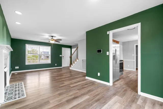 a view of interior space with wooden floor and window