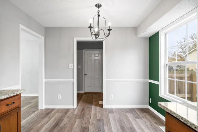 a view of wooden floor and windows in a room