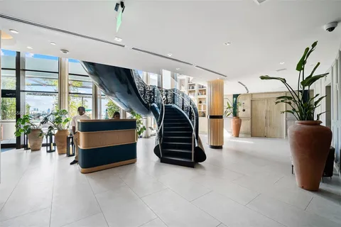 a kitchen with stainless steel appliances wooden floor dining table and chairs