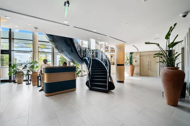 a kitchen with stainless steel appliances wooden floor dining table and chairs