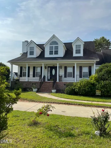 a front view of a house with a yard table and chairs