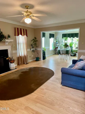 a living room with furniture flowerpot and a window