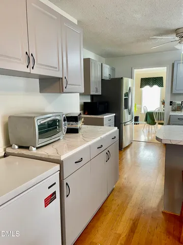 a kitchen with a stove and a refrigerator