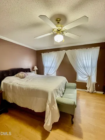 a bedroom with a bed and ceiling fan
