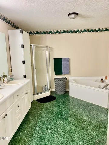 a bathroom with a tub sink and mirror