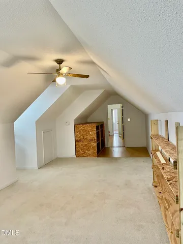 a front view of a house with a garden and trees