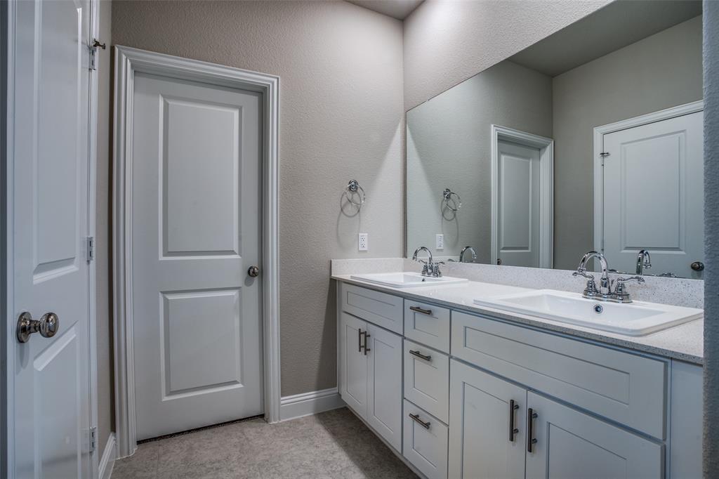 2708 Country Church Road McKinney, TX 75071 - Photo 11 of 12 a bathroom with a double vanity sink and mirror