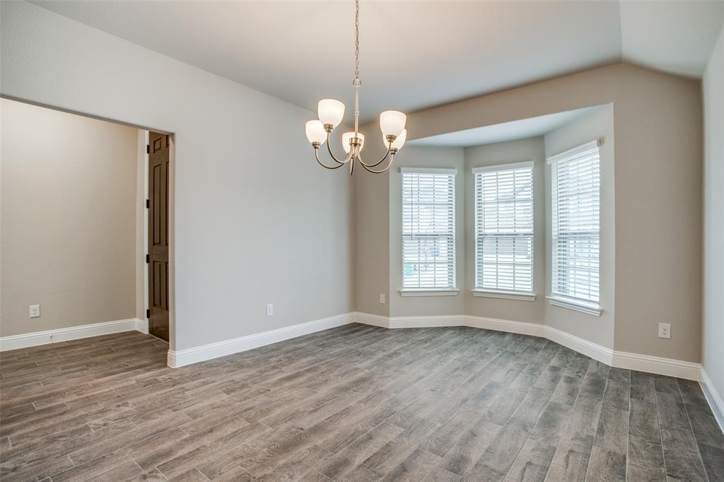 2708 Country Church Road McKinney, TX 75071 - Photo 3 of 12 a view of an empty room with a window and wooden floor