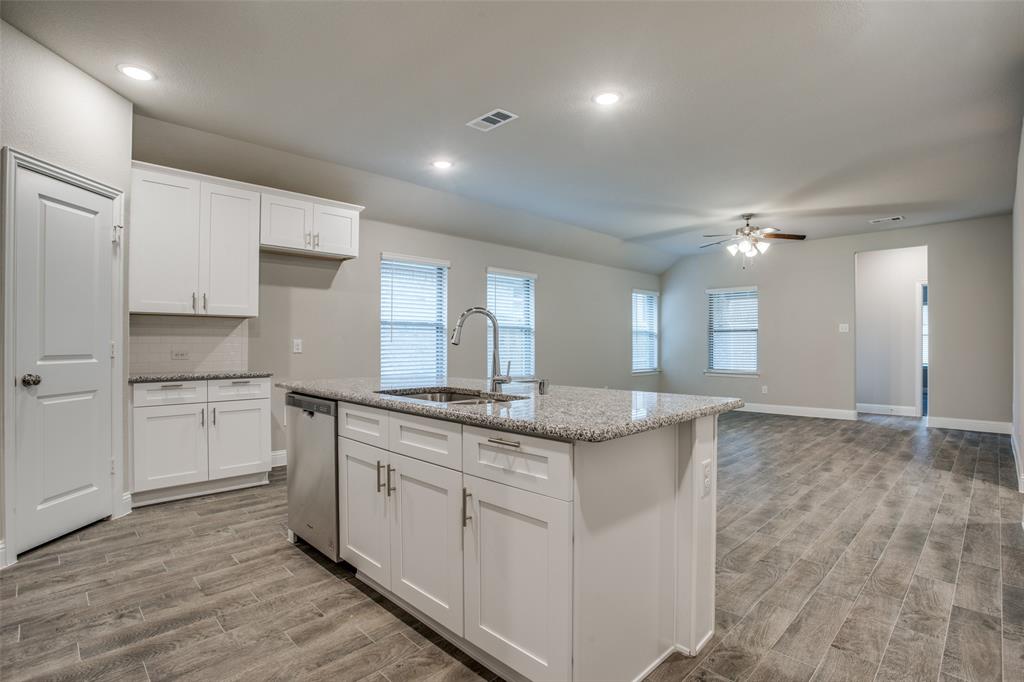 2708 Country Church Road McKinney, TX 75071 - Photo 4 of 12 a kitchen with a sink stove and cabinets