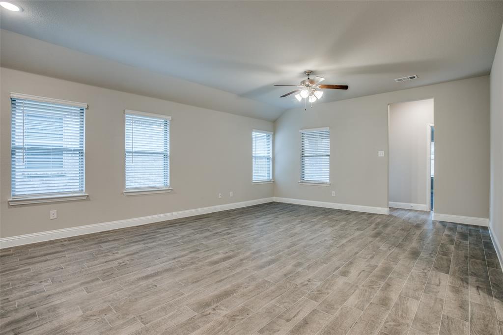 2708 Country Church Road McKinney, TX 75071 - Photo 8 of 12 a view of empty room with wooden floor and fan
