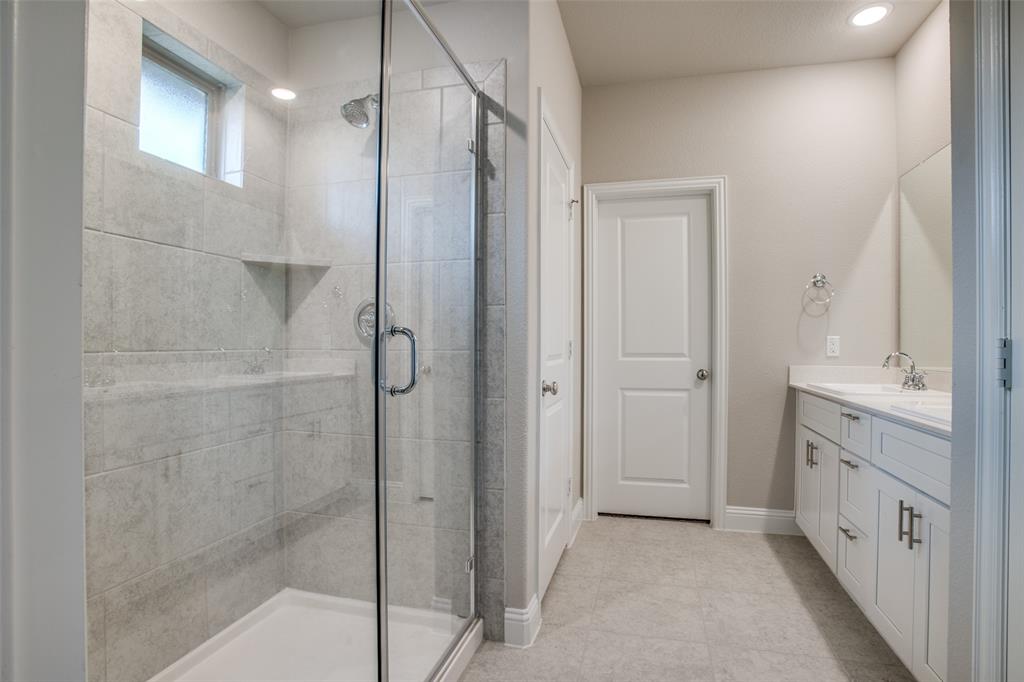 2708 Country Church Road McKinney, TX 75071 - Photo 10 of 12 a bathroom with a double vanity sink a shower and a mirror