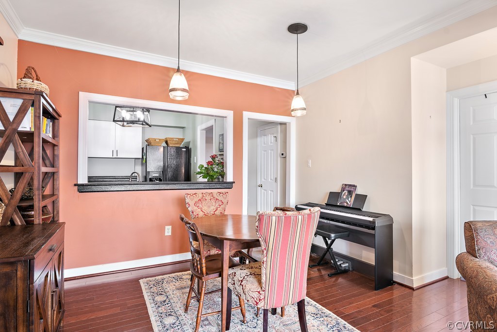 1767 Raintree Commons Drive Henrico, VA 23238 - Photo 14 of 27 a dining room with furniture a chandelier and wooden floor