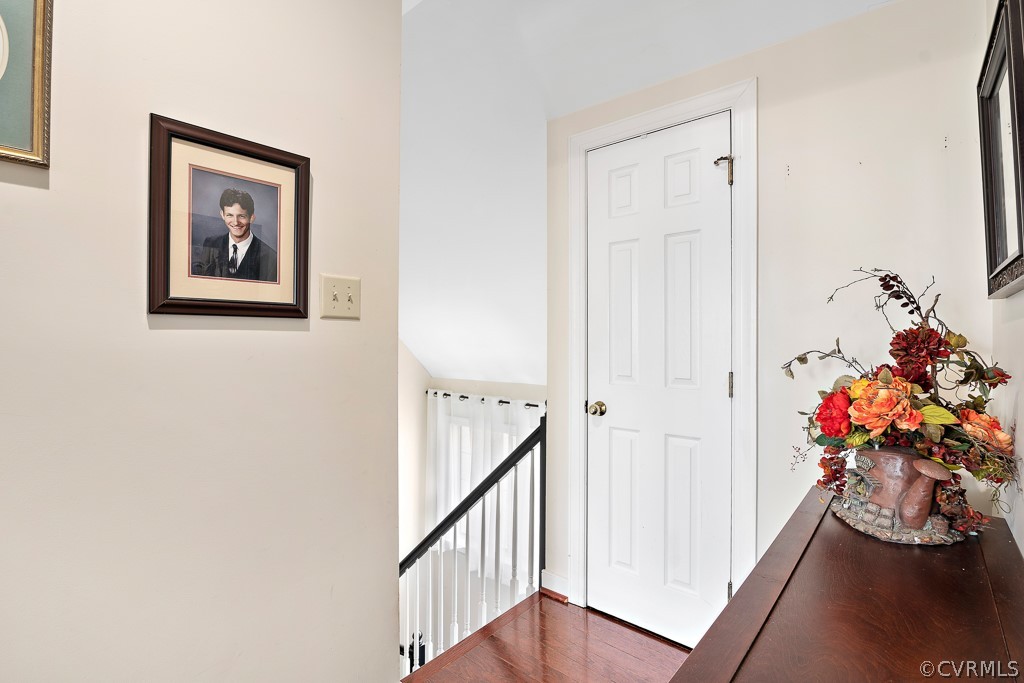 1767 Raintree Commons Drive Henrico, VA 23238 - Photo 8 of 27 a view of a hallway with wooden floor and a dining table