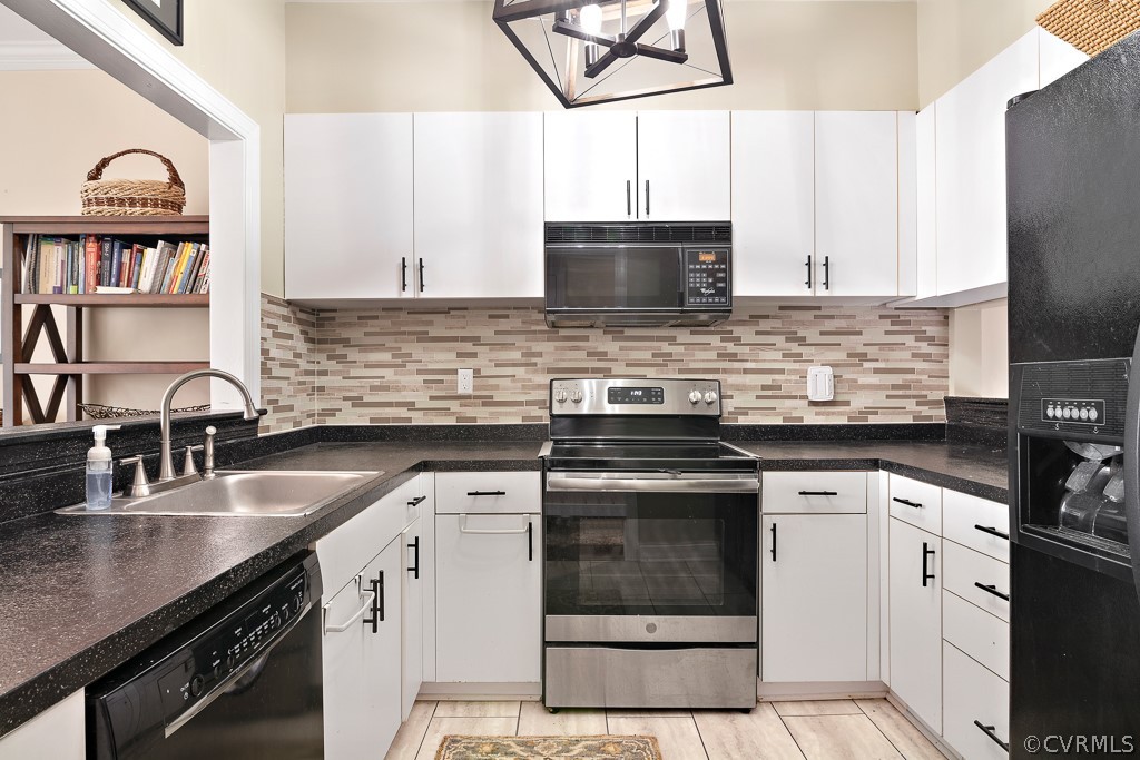 1767 Raintree Commons Drive Henrico, VA 23238 - Photo 9 of 27 a kitchen with stainless steel appliances granite countertop a stove a sink and a microwave