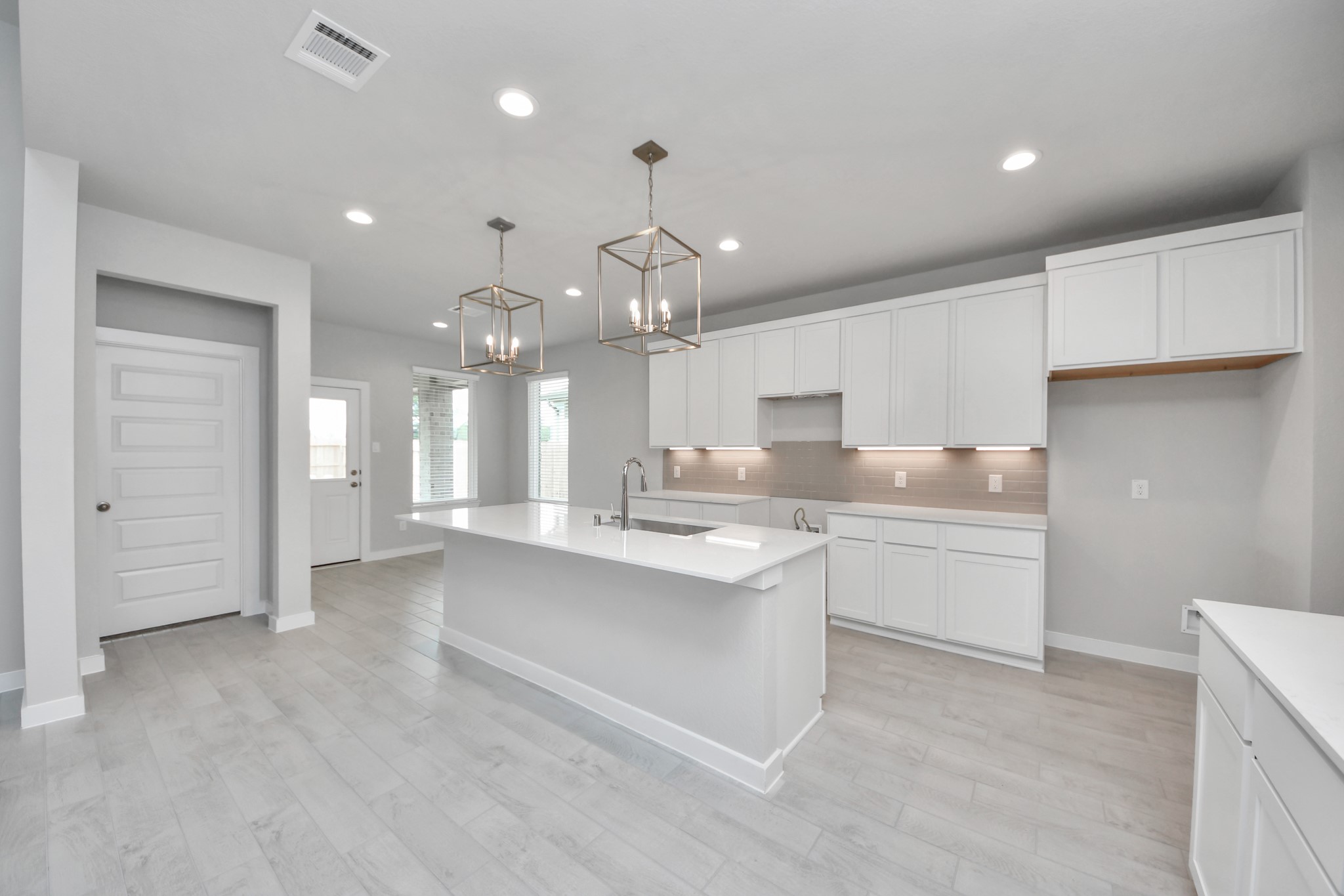 11114 Tulip Rdg Trail Houston, TX 77044 - Photo 10 of 30 The extended counter area adds both practicality and style, making meal preparation a breeze. Every detail is thoughtfully designed to enhance the kitchen's functionality and aesthetic appeal. Sample photo of completed home with similar floor plan. Actual colors and selections may vary.