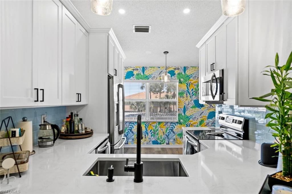 137 Wading Bird Circle, Unit F203 Naples, FL 34110 - Photo 2 of 3 a view of a room with gym equipment