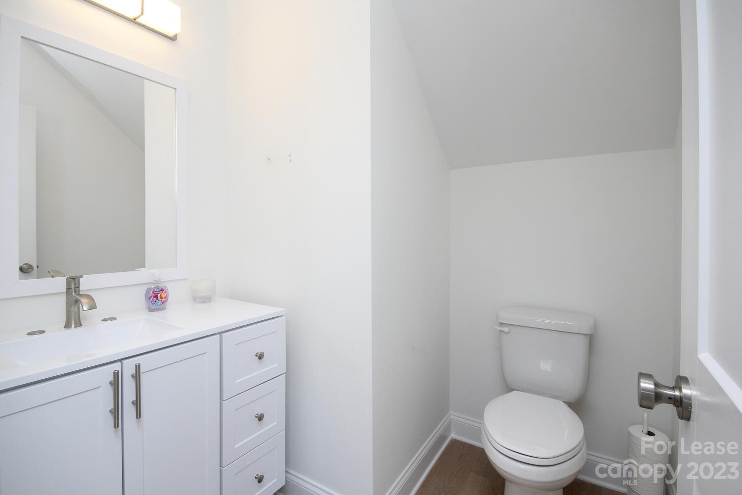 1084 Startown Road Lincolnton, NC 28092 - Photo 17 of 48 a bathroom with a toilet sink vanity and mirror