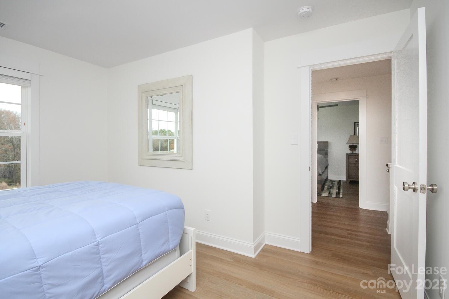 1084 Startown Road Lincolnton, NC 28092 - Photo 37 of 48 a bedroom with a bed and wooden floor