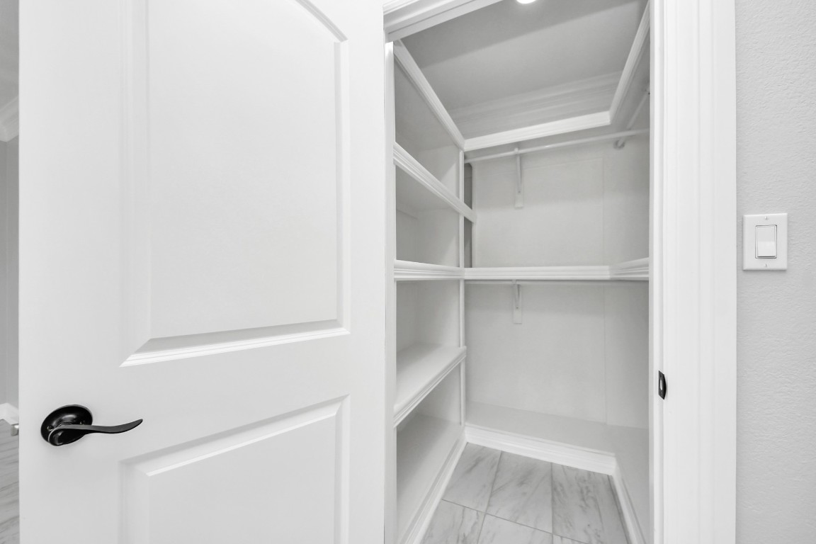 16121 Palm Street Channelview, TX 77530 - Photo 15 of 26 a view of walk in closet with empty racks
