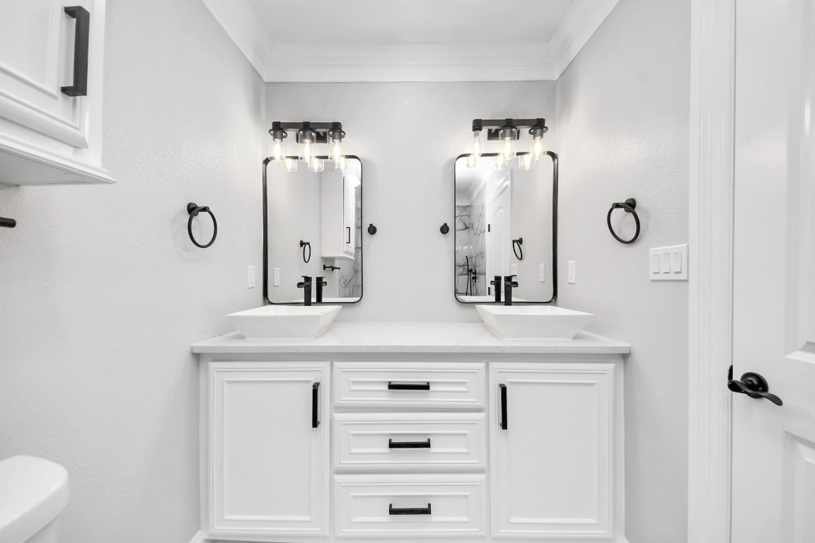16121 Palm Street Channelview, TX 77530 - Photo 17 of 26 a bathroom with double vanity sinks and a mirror