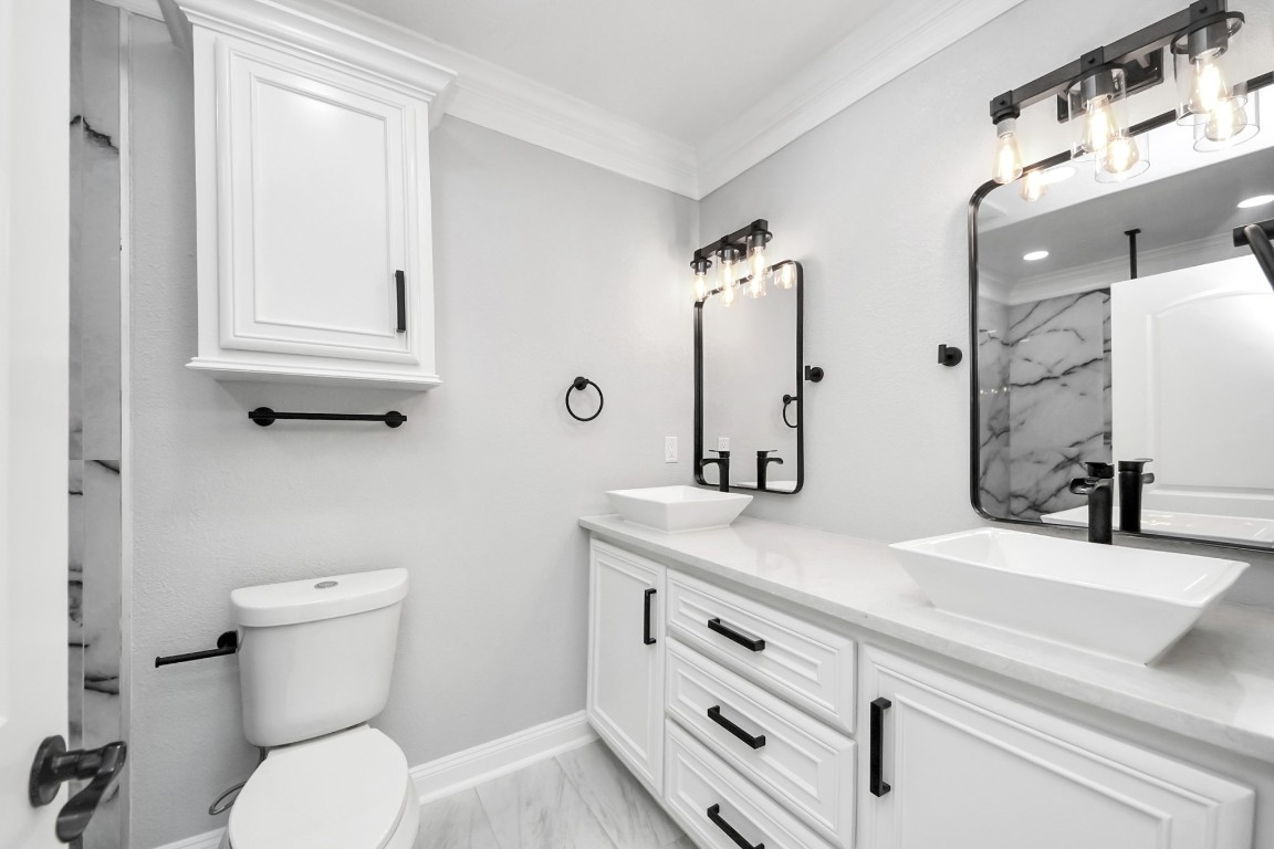 16121 Palm Street Channelview, TX 77530 - Photo 18 of 26 a bathroom with a sink a toilet and a mirror