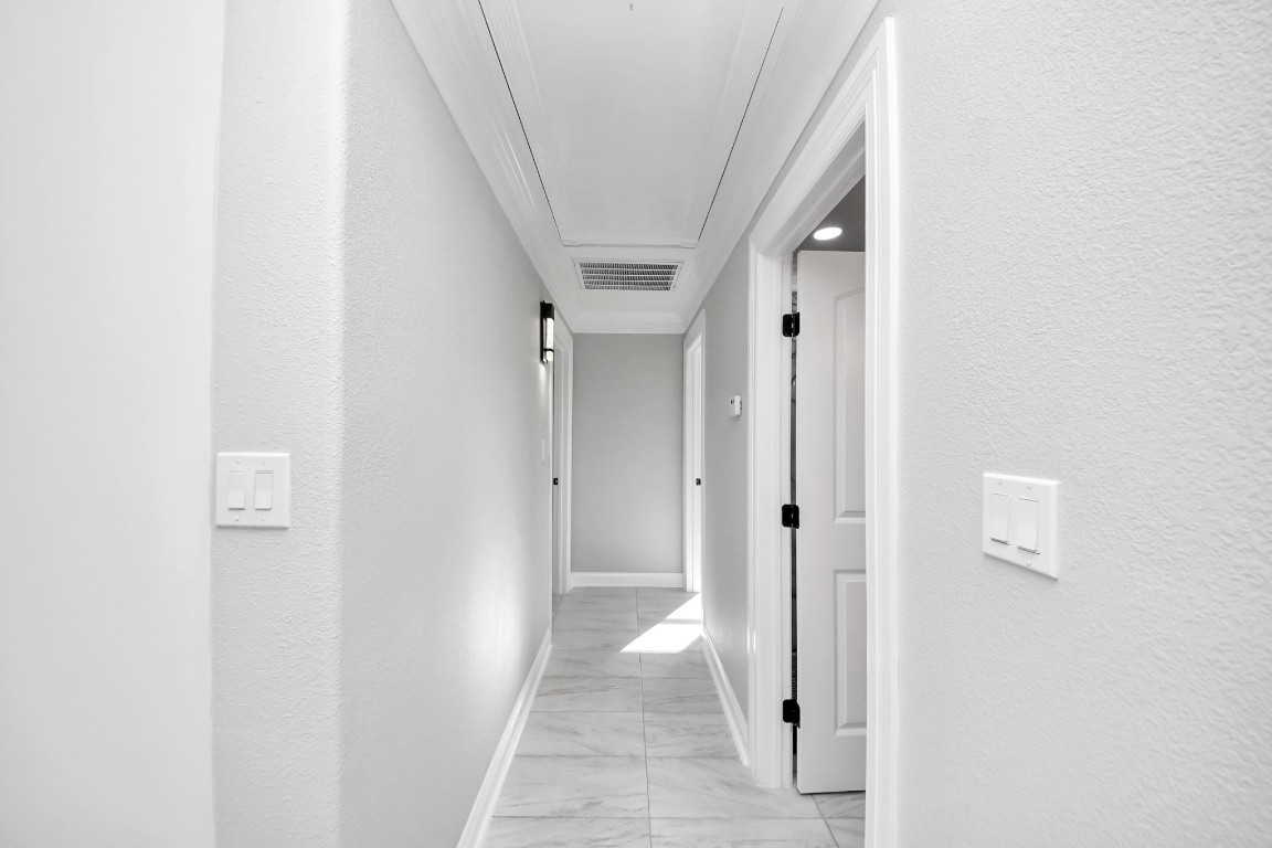 16121 Palm Street Channelview, TX 77530 - Photo 19 of 26 a view of a hallway with wooden shelves