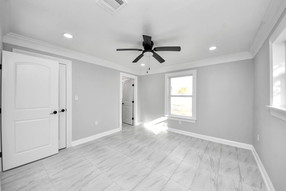 16121 Palm Street Channelview, TX 77530 - Photo 22 of 26 a view of an empty room with window and wooden floor