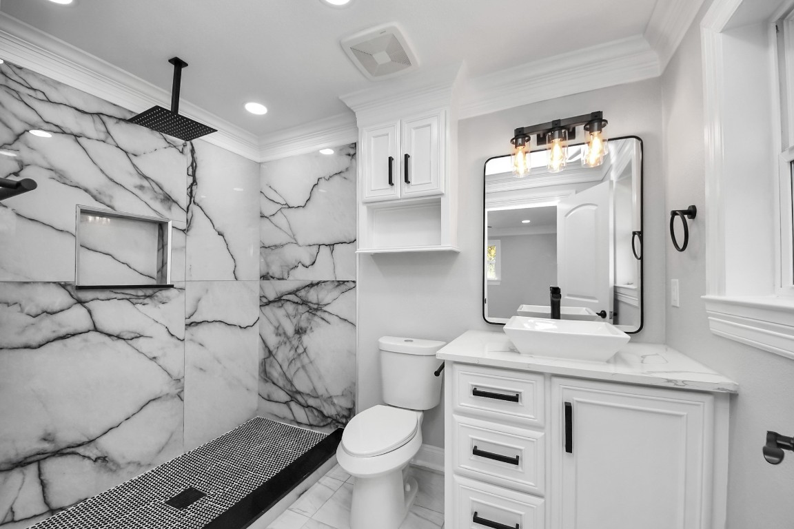16121 Palm Street Channelview, TX 77530 - Photo 23 of 26 a bathroom with a granite countertop sink mirror vanity and toilet