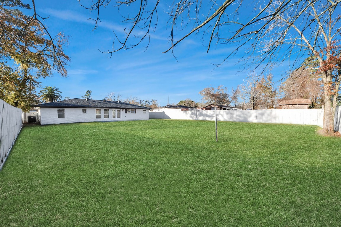 16121 Palm Street Channelview, TX 77530 - Photo 25 of 26 a view of a house with a yard and sitting area