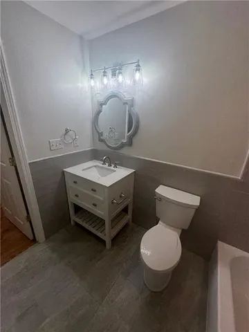 a bathroom with a toilet a sink and view