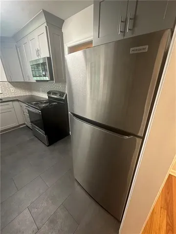 a kitchen with a refrigerator and a stove