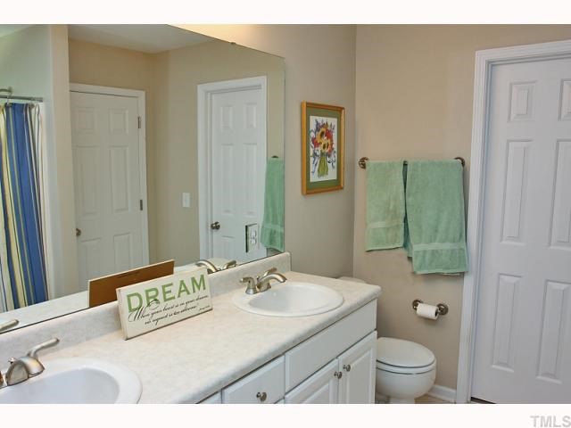 2708 Rustic Brick Road Raleigh, NC 27603 - Photo 8 of 12 a bathroom with a sink a toilet and shower