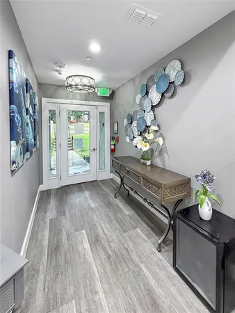 a living room with furniture and a chandelier