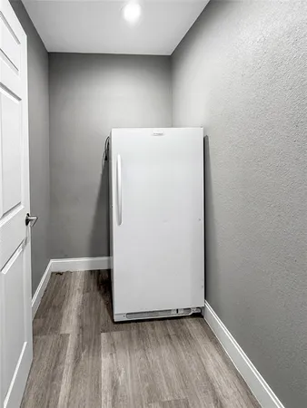 a view of room with closet and wooden floor