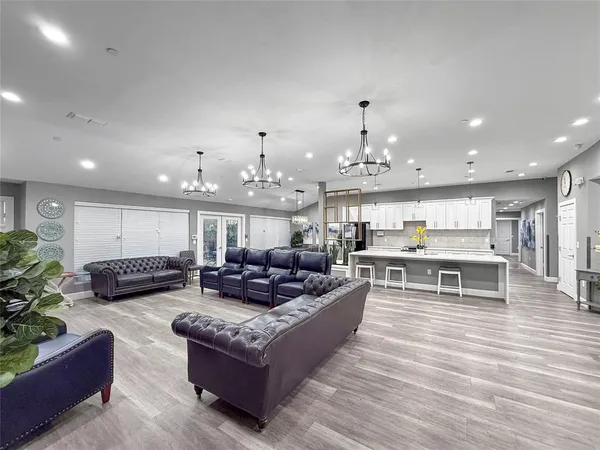 a living room with furniture and kitchen view