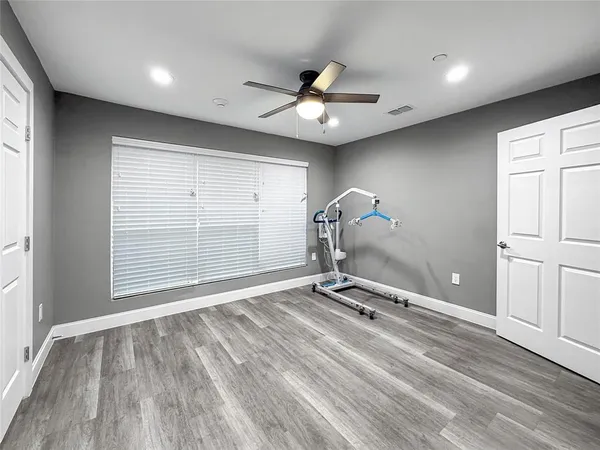 a view of a room with gym equipment and a large window