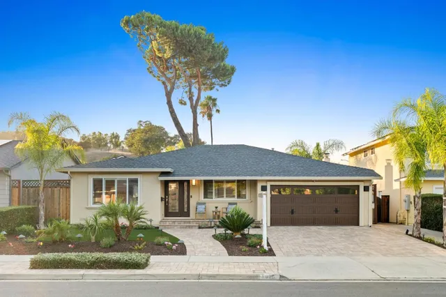 a front view of a house with garden
