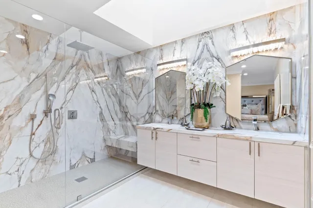 a bathroom with a double vanity sink mirror and