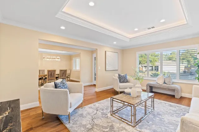 a living room with fireplace furniture and a large window