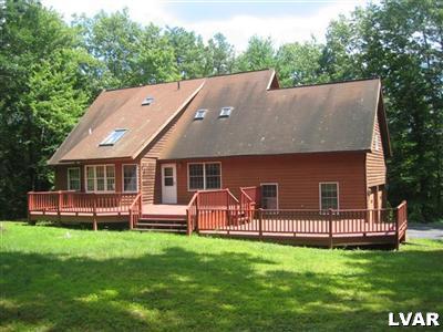 an aerial view of a house with a backyard