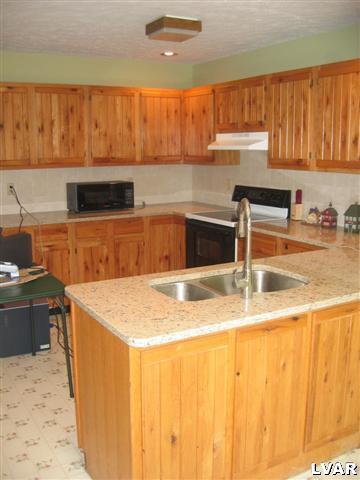 1320 Kroucher Road Stroudsburg, PA 18360 - Photo 2 of 27 a kitchen with stainless steel appliances granite countertop a sink a stove and a microwave