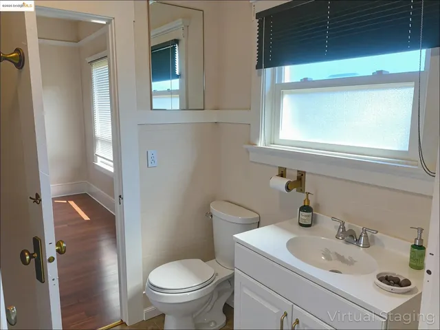 a bathroom with a sink toilet and mirror