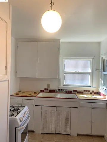 a kitchen with stainless steel appliances granite countertop a sink and a stove