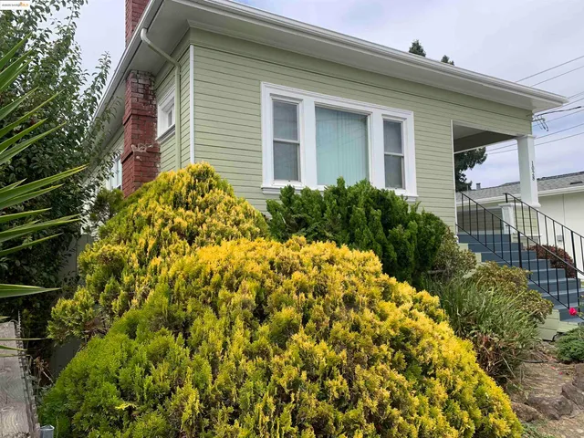 a view of a house with a flower garden
