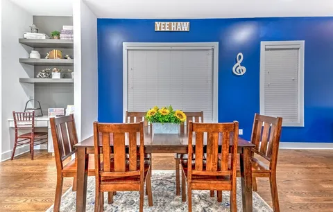 a bedroom with a bed and painting on the wall