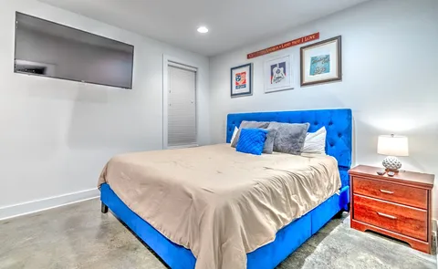 a bedroom with a bed and a flat screen tv