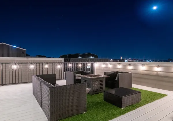a view of a patio with table and chairs with wooden floor and fence
