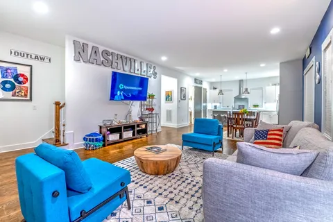 a living room with furniture kitchen view and a table