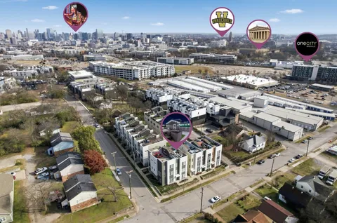 a kitchen with kitchen island a sink a counter top space stainless steel appliances and a window