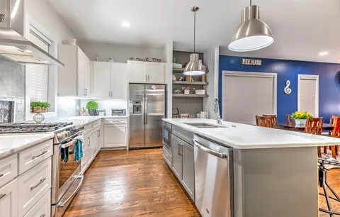 a kitchen with a dining table a sink and a chandelier